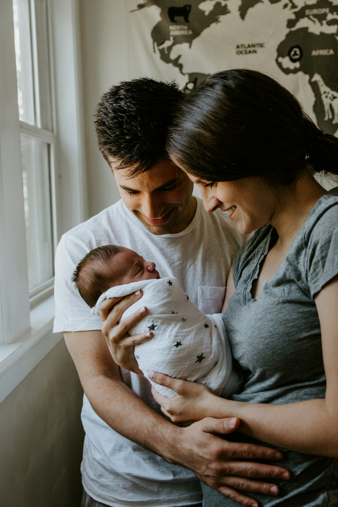 Life2Health Hero Image of man and woman holding newborn baby and smiling