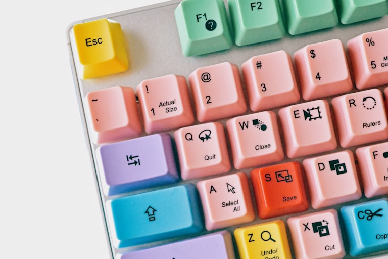 Mechanical keyboard with white, pastel pink, yellow and red keycaps.