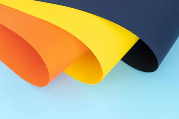 orange, yellow and blue papers by unsplash user @brizmaker