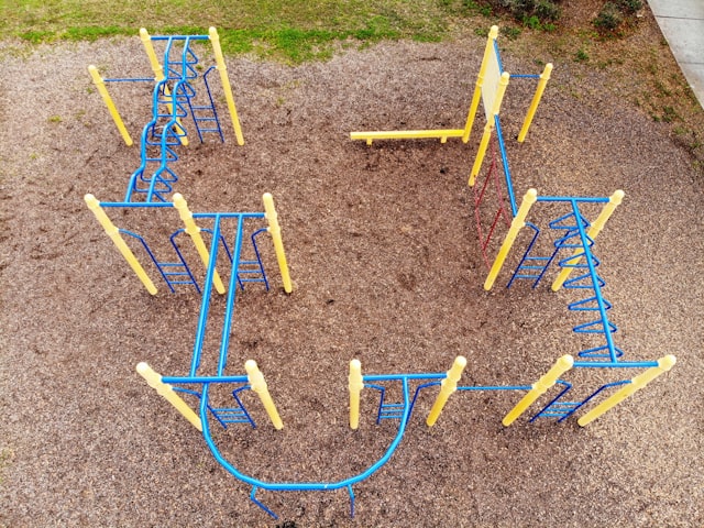 blue and yellow playground by unsplash user @wildfirewilly