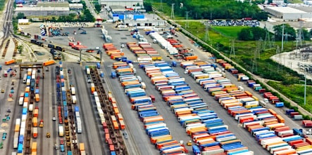 A photograph of intermodal containers parked at a rail yard.