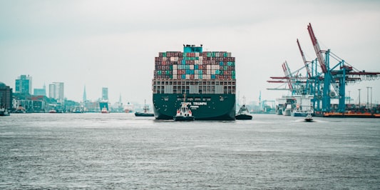 Tugboats guide a Maersk container ship at the Yangshan Deepwater Port, Shanghai. 