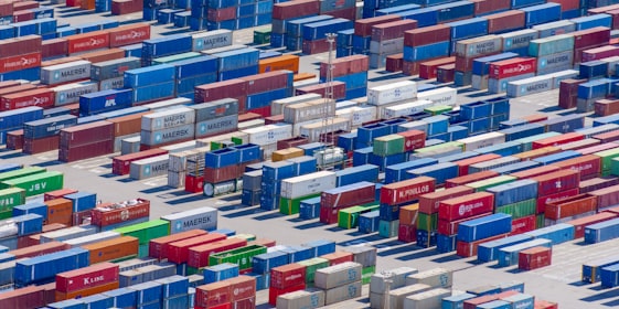 Aerial view of containers stacked at a port.