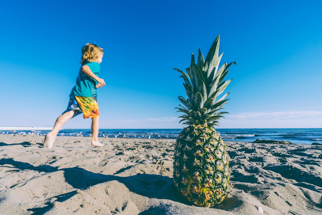 high-resolution pineapple image with boy running on beach