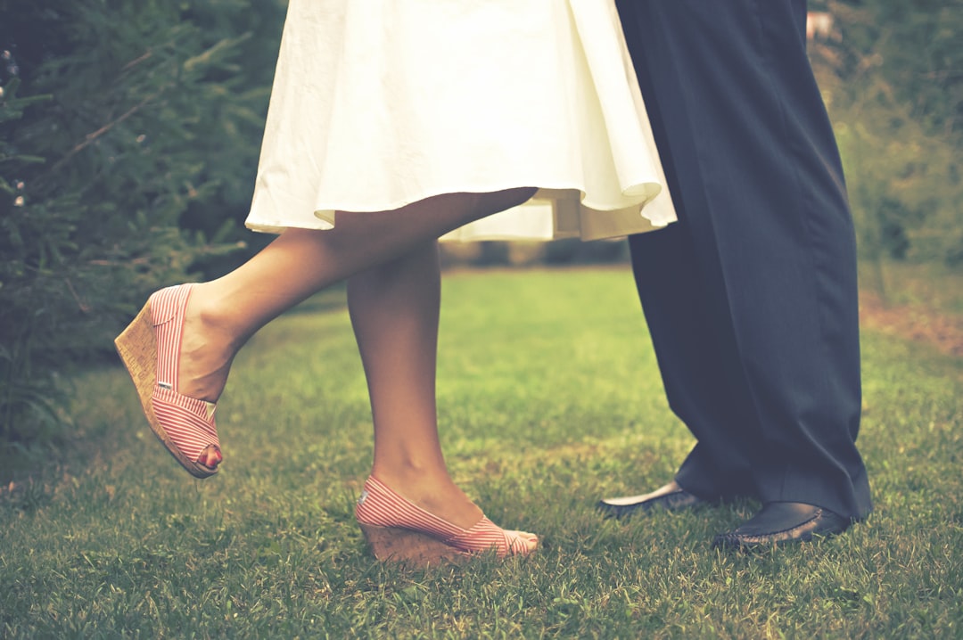 Free high-res photo of bride and groom feet while kissing in grass